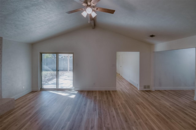 unfurnished living room featuring lofted ceiling with beams, ceiling fan, a textured ceiling, and light hardwood / wood-style floors