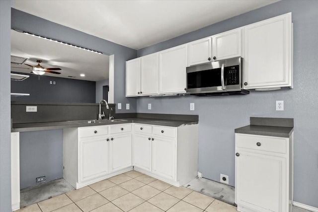 kitchen with sink, white cabinets, and ceiling fan