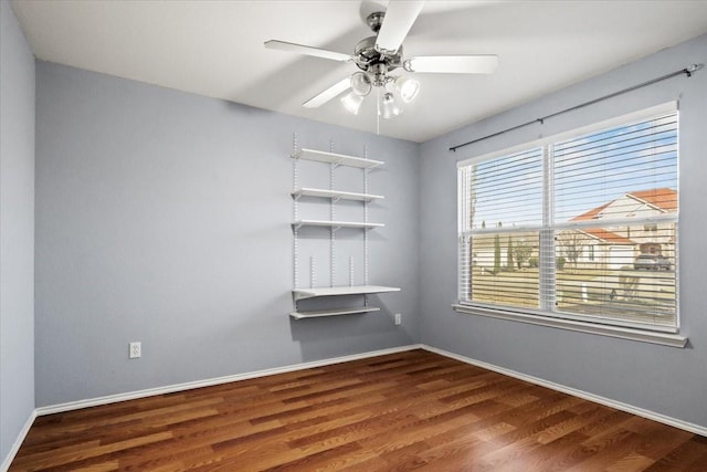 empty room featuring hardwood / wood-style flooring and ceiling fan