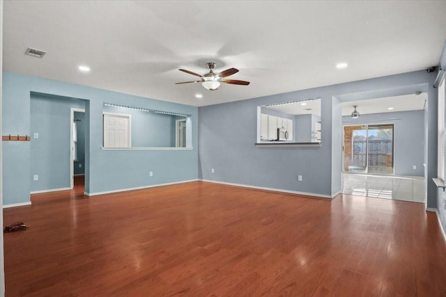 unfurnished living room featuring wood-type flooring and ceiling fan