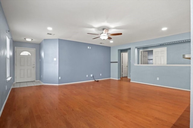 unfurnished living room with ceiling fan and light hardwood / wood-style floors