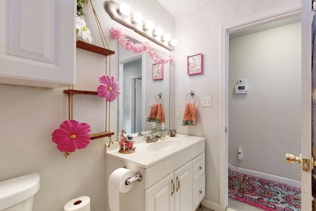 bathroom featuring vanity and toilet