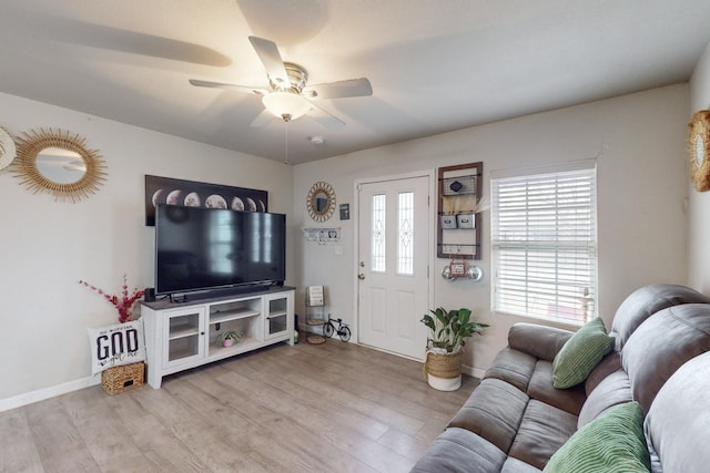 living room with ceiling fan and light hardwood / wood-style floors