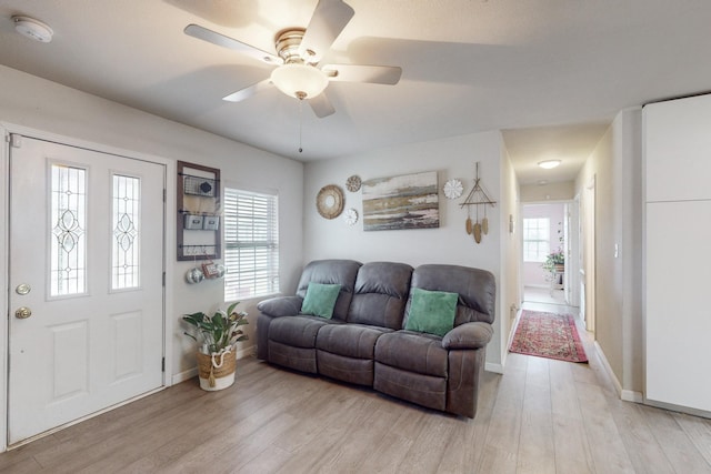 living room with ceiling fan and light hardwood / wood-style flooring