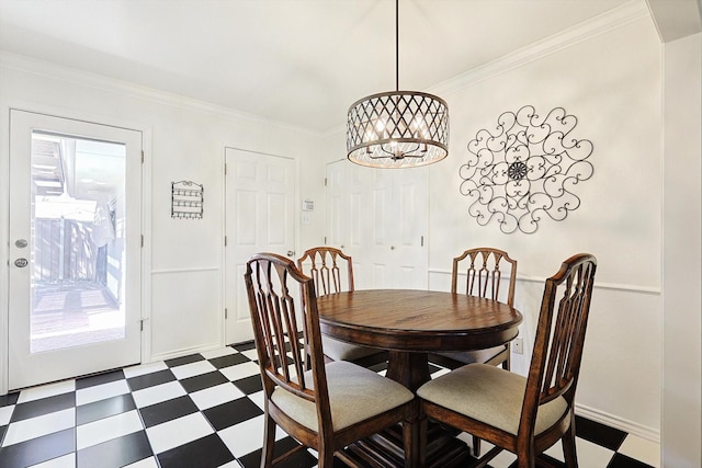 dining area featuring a notable chandelier and crown molding