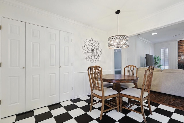 dining room featuring ornamental molding and a notable chandelier