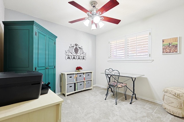 carpeted office space with ceiling fan