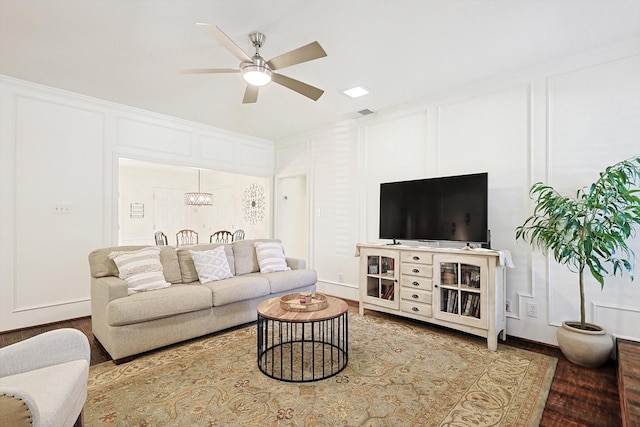 living room featuring hardwood / wood-style flooring and ceiling fan