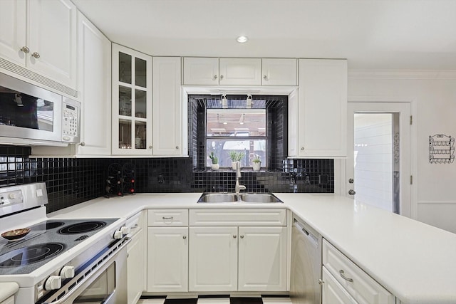 kitchen with white cabinetry, sink, and electric range