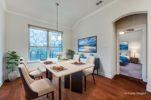 dining area with crown molding and dark hardwood / wood-style floors