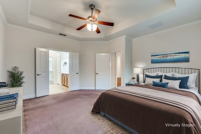 carpeted empty room featuring a raised ceiling, ornamental molding, and ceiling fan