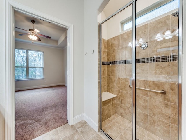 bathroom with an enclosed shower, tile patterned flooring, a raised ceiling, and ceiling fan