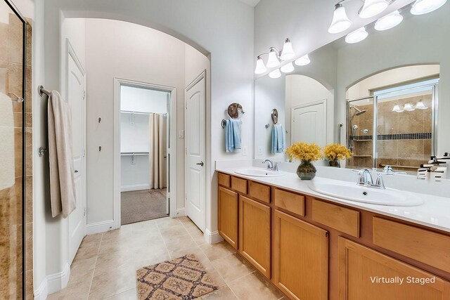 bathroom featuring vanity, tile patterned floors, and walk in shower