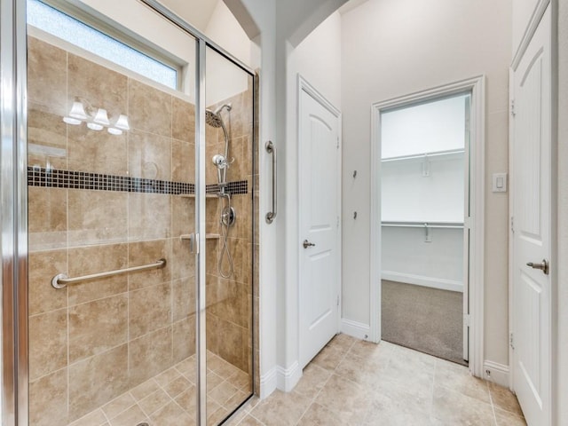 bathroom with tile patterned flooring and walk in shower