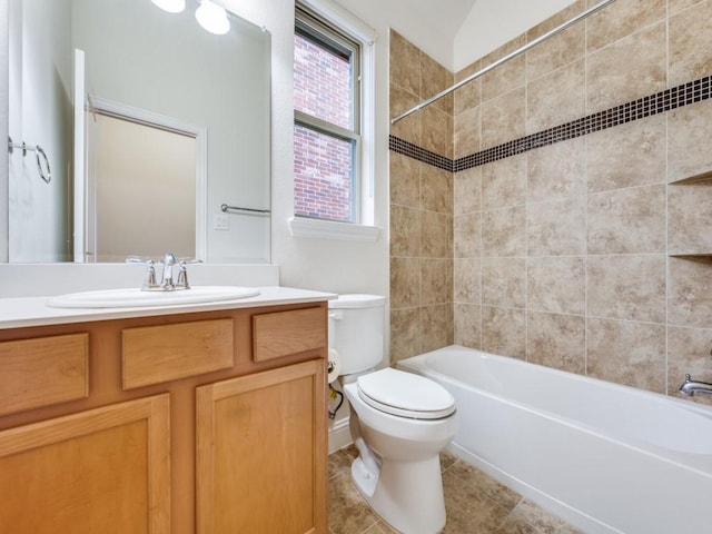 full bathroom featuring vanity, tile patterned flooring, tiled shower / bath combo, and toilet