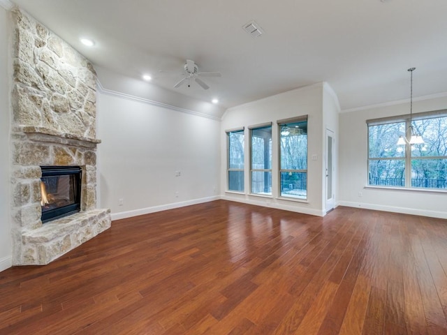 unfurnished living room with crown molding, ceiling fan, wood-type flooring, and a fireplace