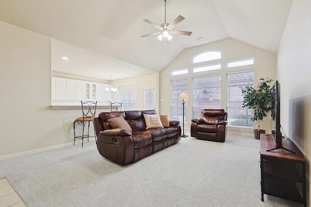 living room with ceiling fan with notable chandelier, light carpet, and high vaulted ceiling