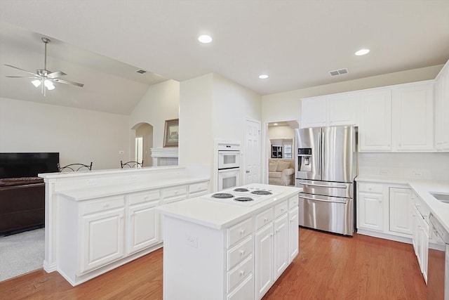 kitchen featuring a center island, white cabinets, white appliances, and light wood-type flooring