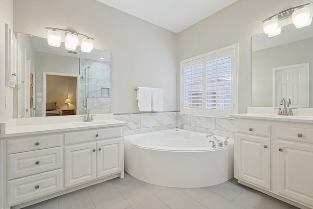 bathroom featuring vanity, tile patterned flooring, and independent shower and bath