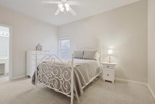 carpeted bedroom with ceiling fan and connected bathroom