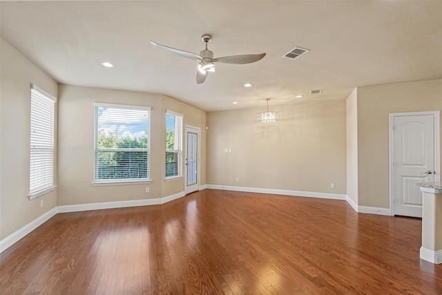 unfurnished room featuring recessed lighting, visible vents, ceiling fan, wood finished floors, and baseboards