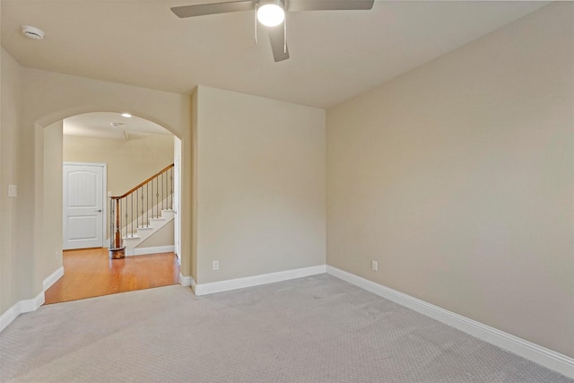 empty room featuring carpet floors and ceiling fan