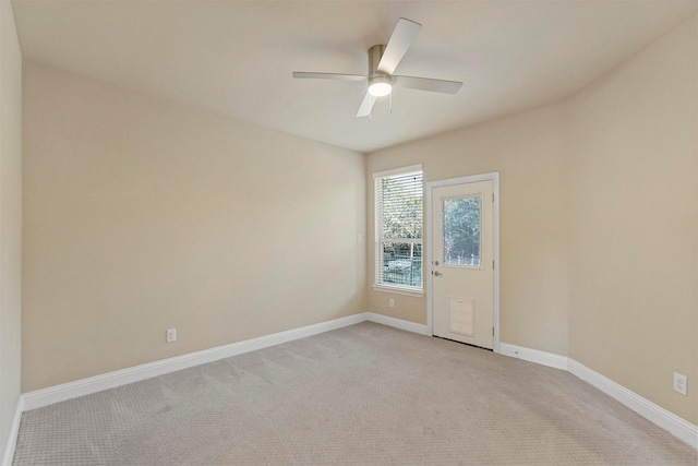 empty room with light carpet, ceiling fan, and baseboards