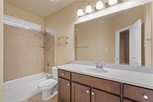 full bathroom featuring tiled shower / bath combo, vanity, tile patterned floors, and toilet