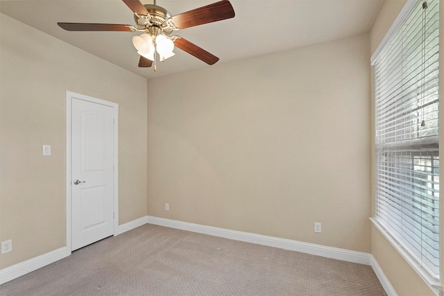 carpeted empty room featuring ceiling fan