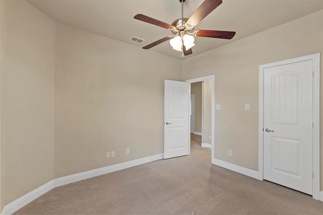 unfurnished bedroom with light carpet, a ceiling fan, visible vents, and baseboards