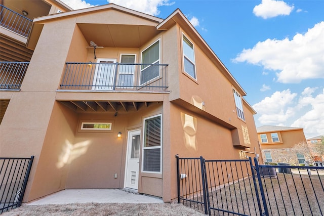 back of property with a balcony