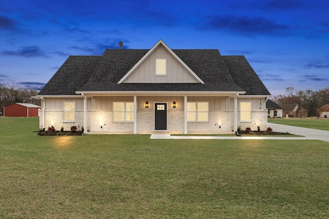 view of front of property with a lawn and covered porch