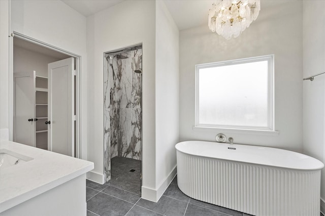 bathroom with an inviting chandelier, vanity, separate shower and tub, and tile patterned flooring