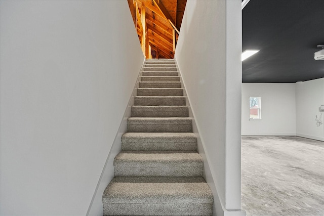 stairway with concrete flooring