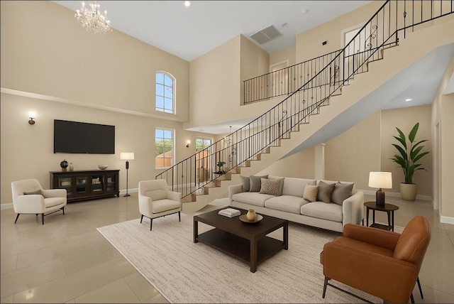 tiled living room with visible vents, baseboards, stairway, and a high ceiling