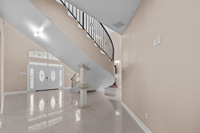 foyer featuring high vaulted ceiling