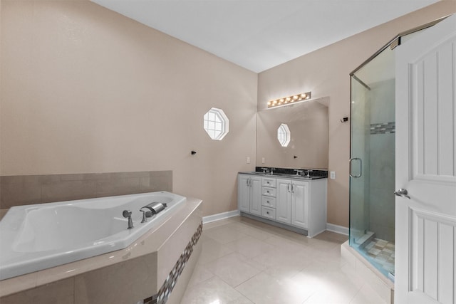 bathroom with a bath, tile patterned flooring, a stall shower, double vanity, and baseboards