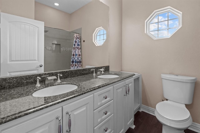 bathroom featuring vanity, hardwood / wood-style floors, curtained shower, and toilet