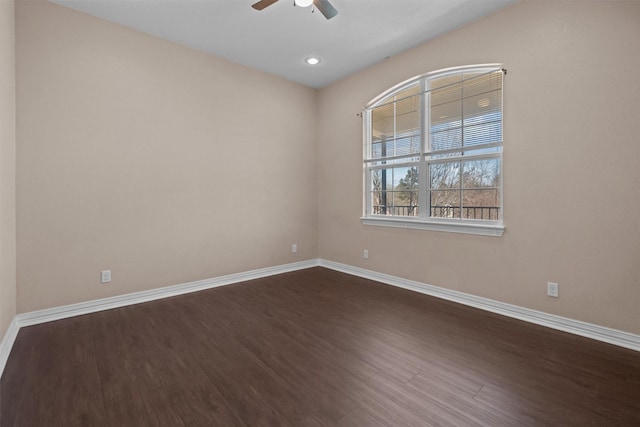 spare room with ceiling fan, recessed lighting, baseboards, and dark wood finished floors