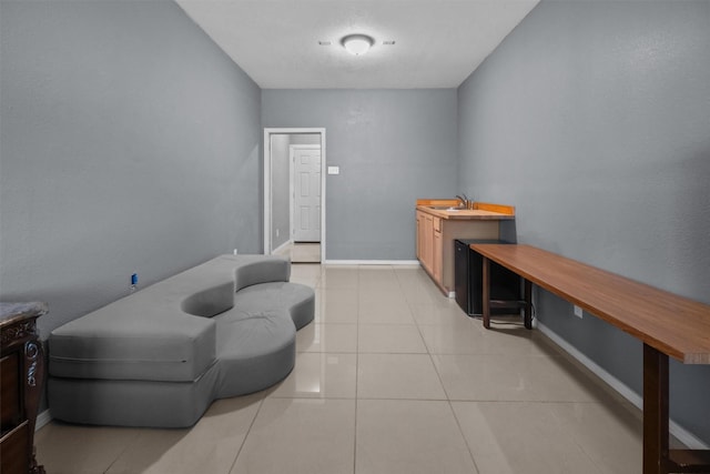 living area with light tile patterned floors and baseboards