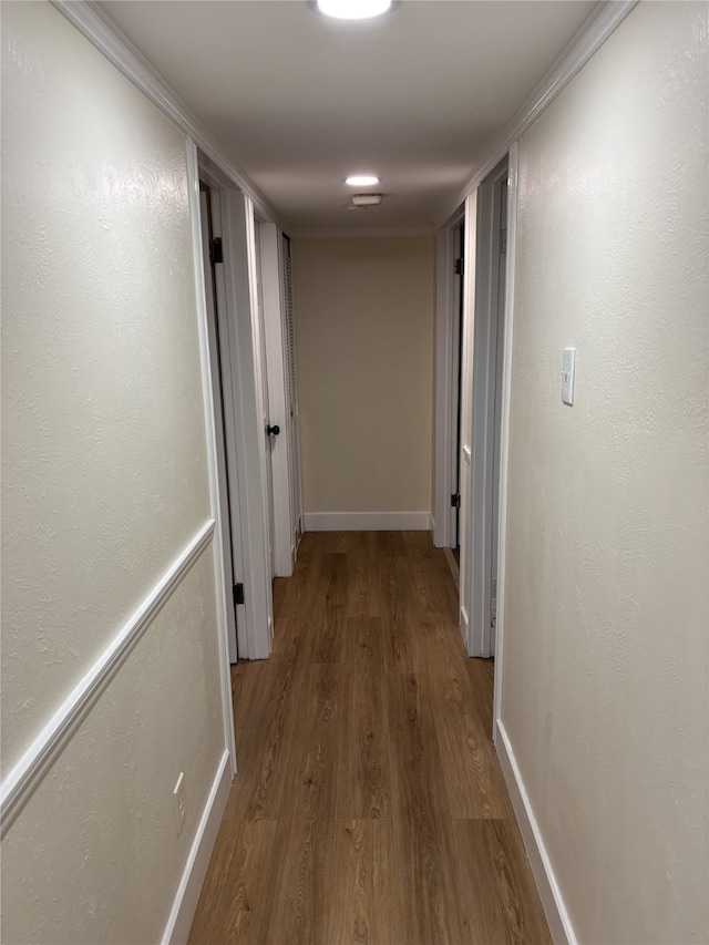 hall with crown molding and hardwood / wood-style floors