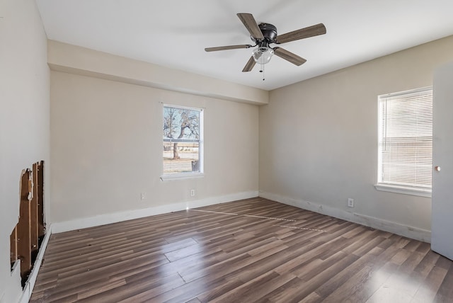 unfurnished room with dark hardwood / wood-style floors and ceiling fan