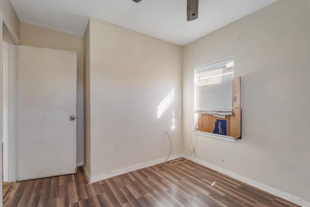 empty room featuring ceiling fan and dark hardwood / wood-style flooring