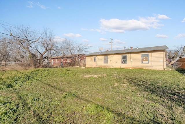 rear view of property with a lawn