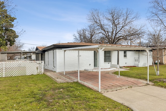 rear view of house featuring a yard