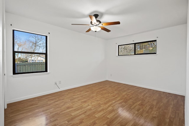 spare room featuring ceiling fan and hardwood / wood-style floors