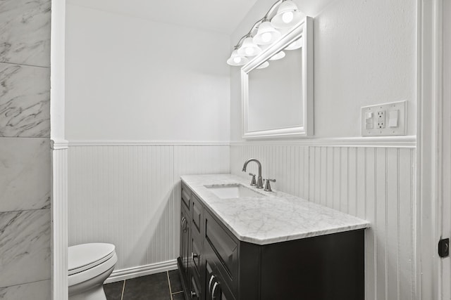 bathroom featuring vanity, tile patterned floors, and toilet