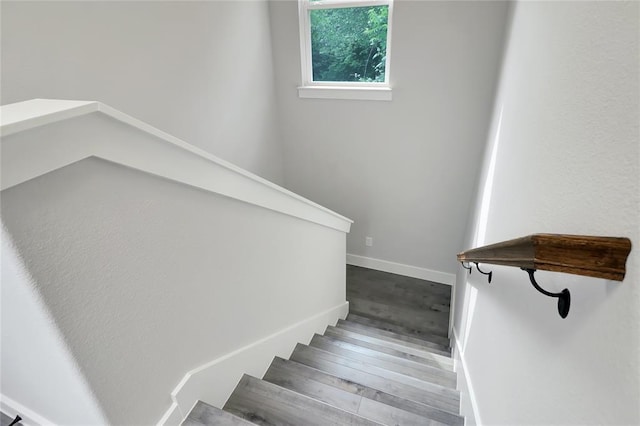 stairs featuring wood-type flooring