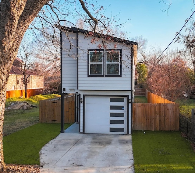 view of front of home with a garage and a front yard