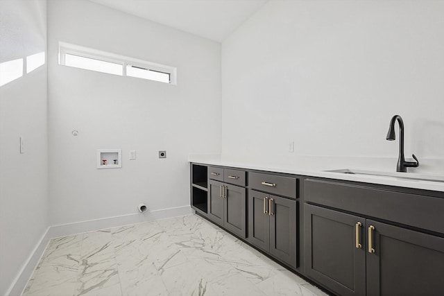 clothes washing area with electric dryer hookup, sink, cabinets, and washer hookup